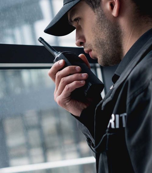 handsome-guard-in-black-uniform-talking-on-walkie-GDJCVQ4.jpg